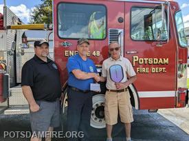 Assistant Chief Farnsworth, and Chief Jerome accept donation from Pickleball player,  Don Tompkins